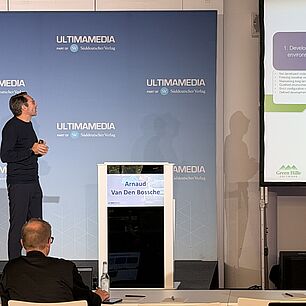 Arnould Van den Bossche as a speaker on stage