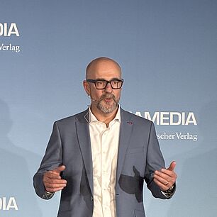 Speaker on Stage at Automotive Software Strategies Conference